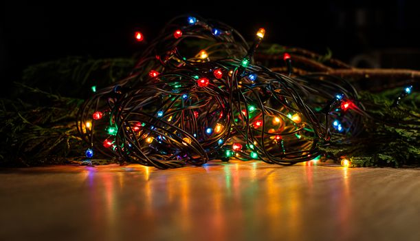Christmas lights on a tree in different colors are classic symbol of Christmas.