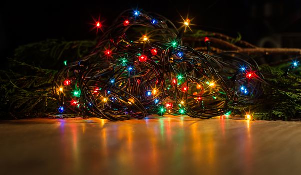 Christmas lights on a tree in different colors are classic symbol of Christmas.