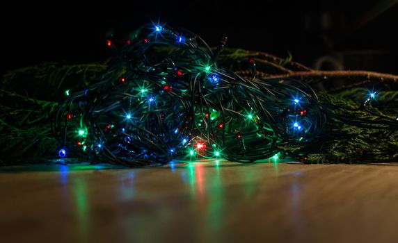 Christmas lights on a tree in different colors are classic symbol of Christmas.