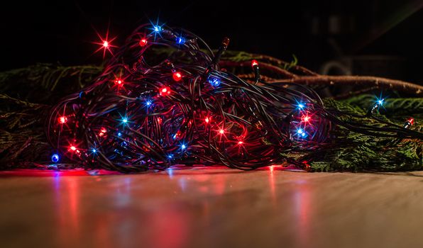 Christmas lights on a tree in different colors are classic symbol of Christmas.
