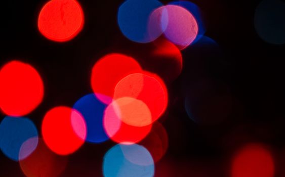 Deliberately blurred Christmas color lights in the background.