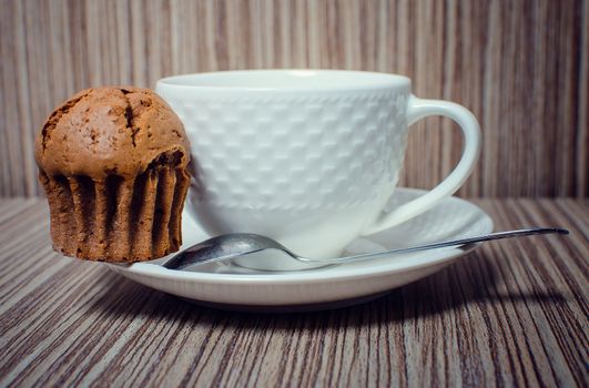 Chocolate muffin and coffee is ideal for a good breakfast.