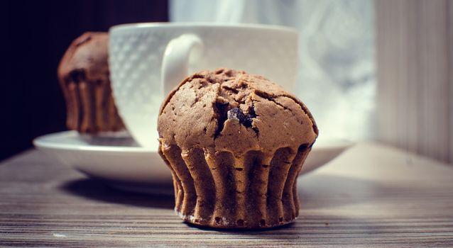 Chocolate muffin and coffee is ideal for a good breakfast.
