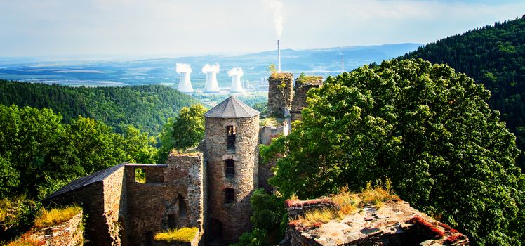 View of the contrast of nature and factory chimneys.