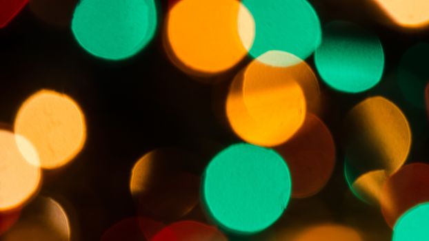 Deliberately blurred Christmas color lights in the background.