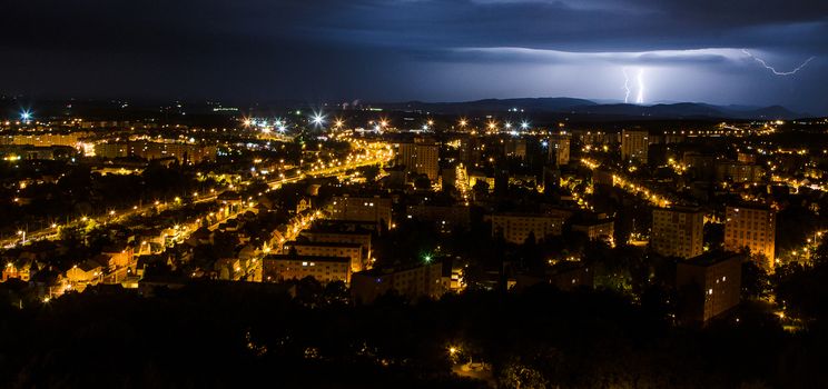 Summer lightning and a storm over the city from hot weather.