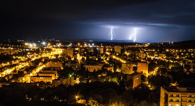 Summer lightning and a storm over the city from hot weather.
