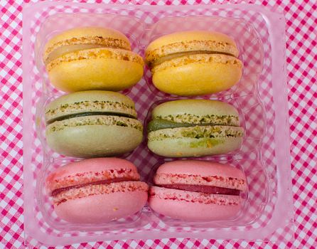 Colorful sweet macaroons on retro background.