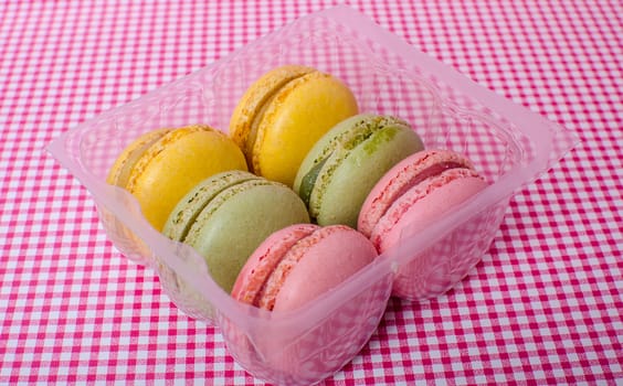 Colorful sweet macaroons on retro background.