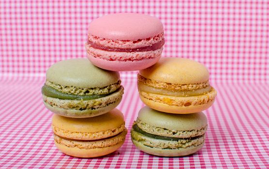 Colorful sweet macaroons on retro background.