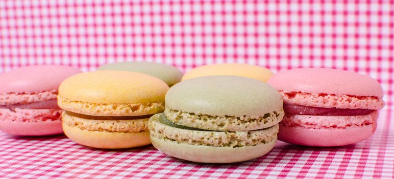Colorful sweet macaroons on retro background.