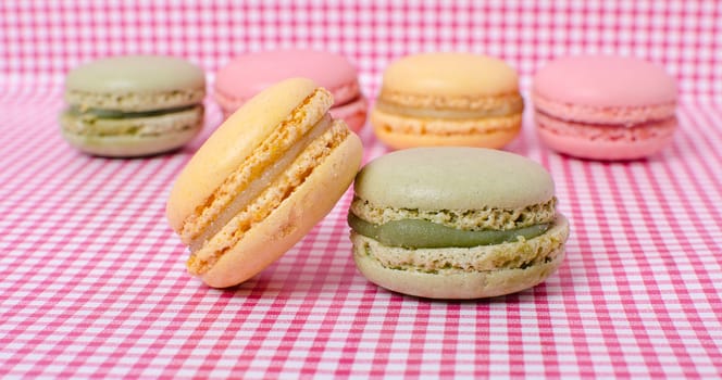 Colorful sweet macaroons on retro background.