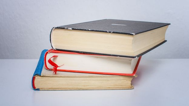 A pile of old, discarded books suited to learning.