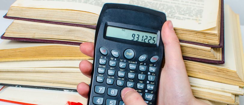 A  pile of books and a calculator help in learning.