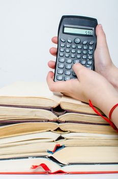 A  pile of books and a calculator help in learning.
