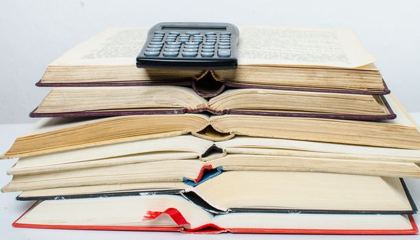 A  pile of books and a calculator help in learning.