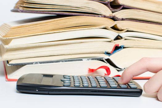 A  pile of books and a calculator help in learning.