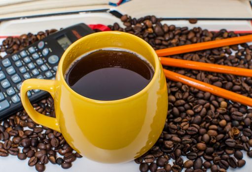 A  pile of books calculator and coffee help in learning.