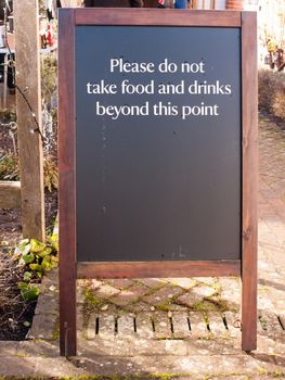 outside area restriction sign cafe - please do not take food and drinks beyond this point black and wood chalkboard; essex; england; uk