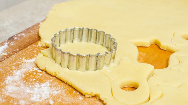 Cutting and baking Christmas cookies in Advent Time.