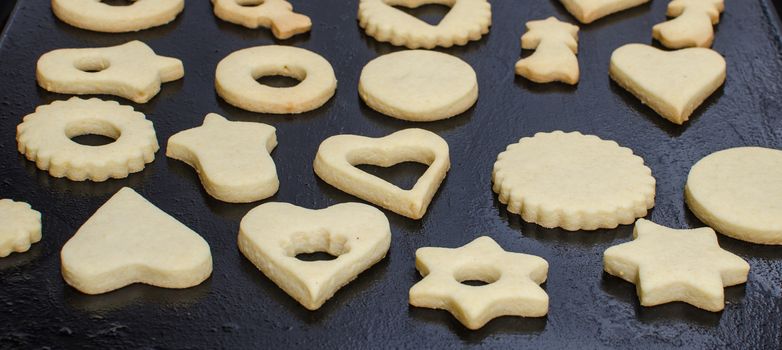 Cutting and baking Christmas cookies in Advent Time.