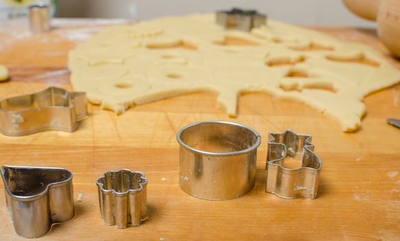 Cutting and baking Christmas cookies in Advent Time.