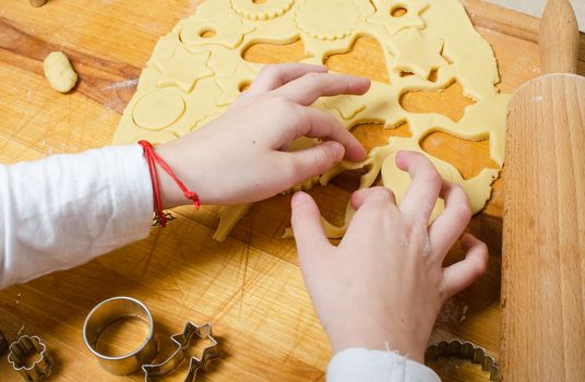 Cutting and baking Christmas cookies in Advent Time.