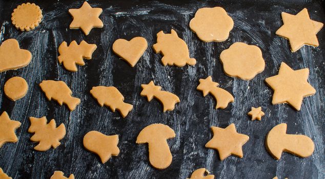 Cutting and baking Christmas gingerbread in Advent Time