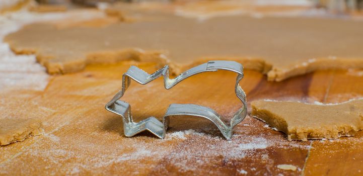 Cutting and baking Christmas gingerbread in Advent Time