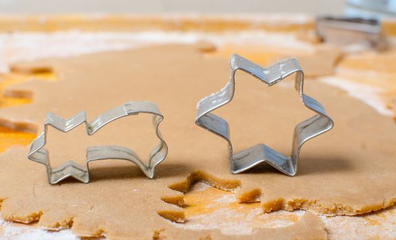 Cutting and baking Christmas gingerbread in Advent Time