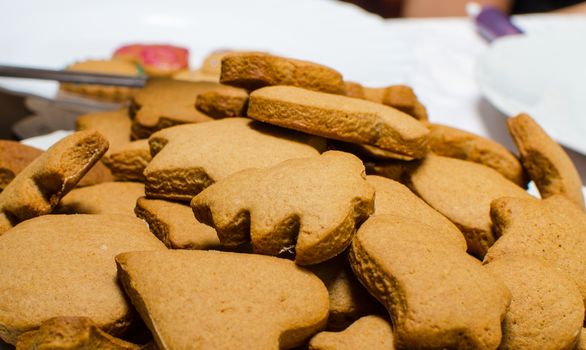 Cutting and baking Christmas gingerbread in Advent Time