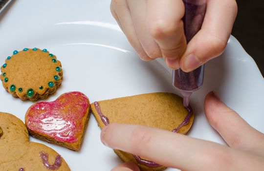 Cutting and baking Christmas gingerbread in Advent Time