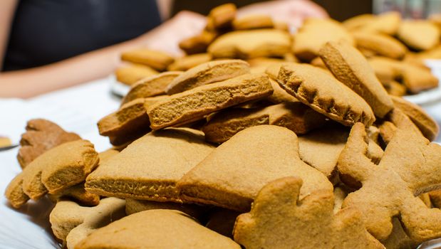 Cutting and baking Christmas gingerbread in Advent Time