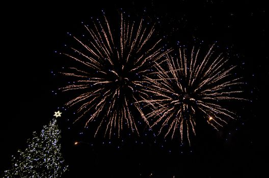 Colorful fireworks in the clouds and the beginning of Christmas time