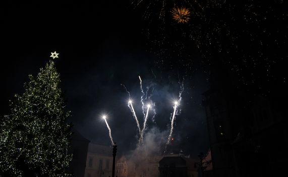 Colorful fireworks in the clouds and the beginning of Christmas time