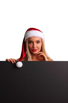 Santa girl holding blank black sign billboard. Christmas woman in Santa hat showing paper sign.