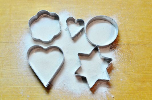 Hands baking Christmas cookies and biscuits.