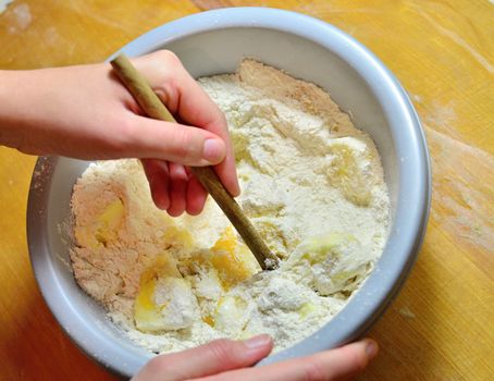 Hands baking Christmas cookies and biscuits.