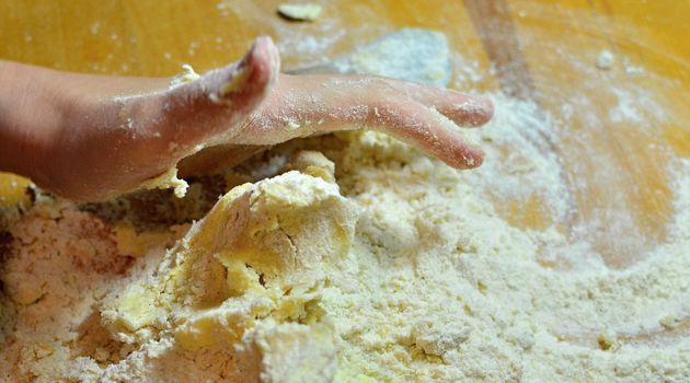 Hands baking Christmas cookies and biscuits.