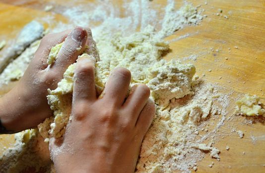 Hands baking Christmas cookies and biscuits.