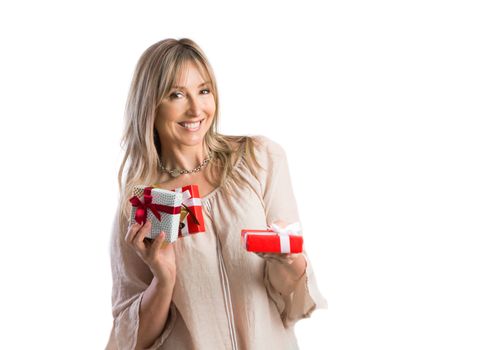 Smiling female holding wrapped gifts and holding one present out   White background