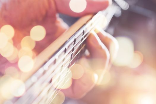 Hands of man playing electric guitar close up