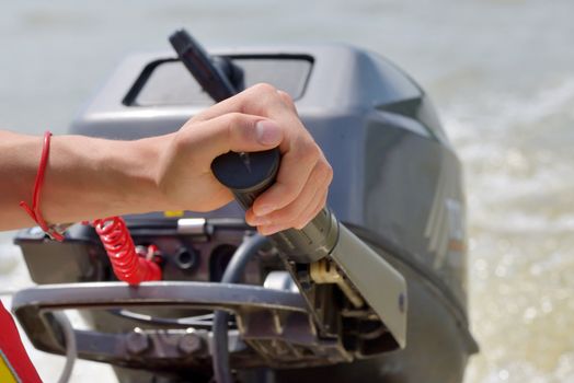 Fisherman hand driving and boat engine