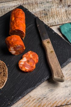 Malt loaf bread and chorizo slices on table.