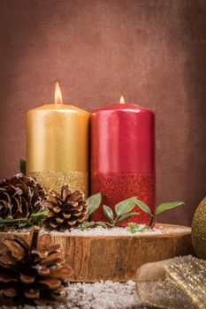 Christmas candles and ornaments over wooden background.