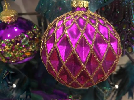 Christmas season.  Fuchsia and gold glitter decorated Christmas tree ornaments
