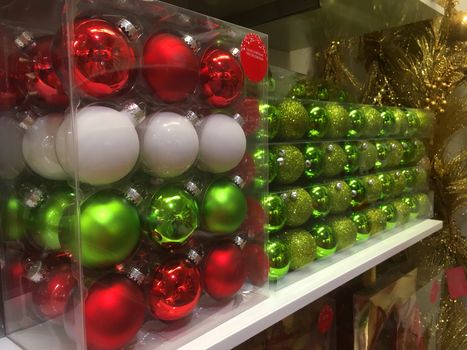 Boxes of glass Christmas tree bauble decorations ready for sale in a store