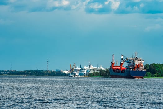 Merchandise import. Large blue cargo ship moving to Riga port