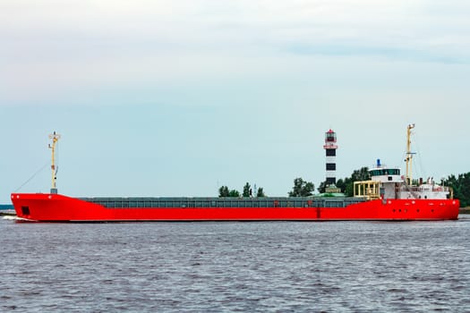 Orange cargo ship. Logistics and merchandise transportations