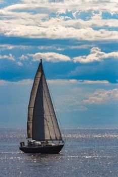 Blue sailboat in travel by Europe. Sea journey